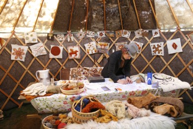 Needle felting activities in Fibershed Yurt, 2013; Photo courtesy David Arelleanes
